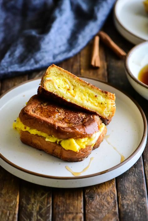 This French Toast Egg & Cheese Breakfast Sandwich recreates the traditional breakfast sandwich by incorporating the flavors of French Toast. #frenchtoast #breakfastsandwich #eggsandwich #breakfastrecipes #breakfastsandwichrecipes #frenchtoastsandwich #frenchtoastrecipe French Toast Grilled Cheese, Toast Egg, French Toast Sandwich, Eggs Cheese Breakfast, Eggs Recipes, Cheesy Eggs, Breakfast Sandwich Recipes, Cheese Breakfast, French Toast Breakfast