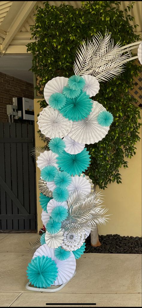 For an 18th birthday party i used teal, white and silver paper fans with silver palm leaves mixed in on this arch. Teal And Silver Birthday Decorations, Teal And White Birthday Decorations, Turquoise And Silver Party Decorations, Teal And Silver Birthday Party Ideas, Teal And Silver Party Decorations, Turquoise And Gold Birthday Party Ideas, Turquoise Party Theme, Aquamarine Birthday Party, Teal Graduation Party Ideas