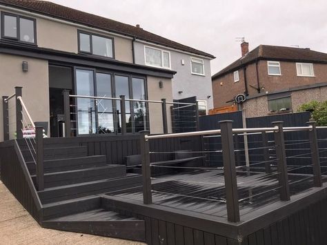 midnight black composite decking boards used to create a multi height decking. Black Decking, Decking Outdoor, Hot Tub Landscaping, Decking Boards, Wpc Decking, Composite Decking Boards, Artificial Hedges, Outdoor Look, Plant Delivery