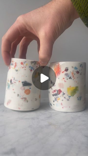 Adrien Miller on Instagram: "Making a terrazzo effect on porcelain slab cups.  I had a bunch of these dried up little chips of colored clay, so I sprinkled them onto puddles of wet slip on slabs to get them rehydrated while maintaining the crisp edges of the color flakes.  I forgot to film the other steps, but there are plenty of slab building videos out there, so here’s the unusual part of the process. Enjoy! #terrazzo #porcelain #process #coloredclay #cups" Clay Slip, Porcelain Slip Dipping, How To Make Clay Slip, Cracked Porcelain, Porcelain Slab, Bubble Underglaze, Pottery Slip, Red Clay, Pottery Techniques