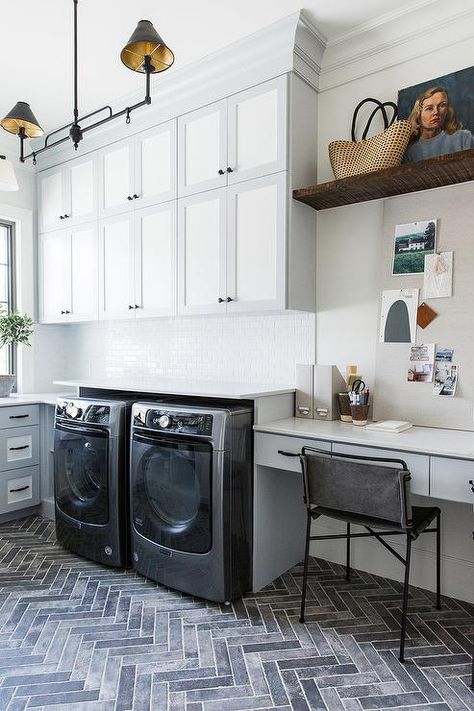 Stacked laundry room cabinets finished in white and gray bring a two-toned design styled with a home office extension. Stacked Laundry Room, Basement Laundry Room, Basement Laundry, Laundry Room Remodel, Laundry Room Cabinets, Cabinet Finishes, Room Renovation, Laundry Room Storage, Laundry Mud Room