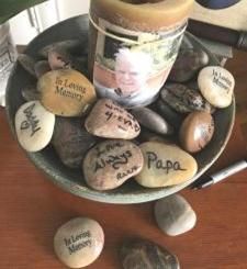 Memory Stones Ideas, Fishing Memorial Ideas, Outdoor Memorial Service Ideas, Memory Garden Ideas Diy, Open Book Wall, Memorial Tree Ideas, Memorial Ideas For Loved Ones, Memory Stones, Memorial Service Decorations