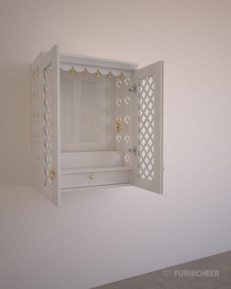 SKU: TLWT2836T Size in cm : L 70 x D 37.5 x H 91.5 Product weight in kg : 36 Package weight in kg : 51 Small enclosed prayer unit to add a spiritual element to your space Features: -Wall mount -Enclosed 2 stepped unit -Drawer to house pooja essentials -Flower cutouts on sides -Trellis shutters -Corniced canopy -Wooden back to mount frames Material: -Phyto-certified American solid Tulip wood -Kiln dried sustainable hardwood -Cherry brown stained premium PU finish by Ica Italy Accessories: -3 brass filigree knobs  -24 small decorative brass bells   -2 brass hanging lamps Hardware: -Branded telescopic slides and soft closing hinges -Branded CKD fittings -Provision for light Assembly and care: -Drawing and video-aided easy assembly instructions -Wipes clean with a damp cloth followed by dry cl Wall Mandir Ideas For Home, Small Pooja Unit, Puja Unit, Mandir For Home, Temple For Home, Mandir Designs, Pooja Unit, Puja Mandir, Gold Bangles Indian