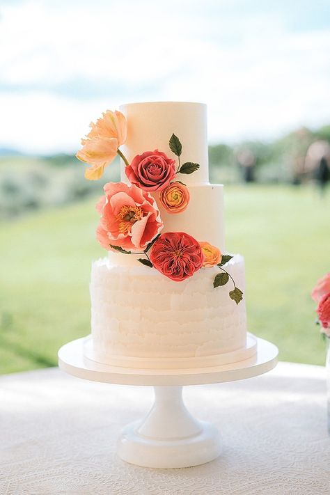 Summer Floral Wedding Cake Wedding Cake Sunset Colors, Simple 3 Tier Wedding Cake With Flowers, August Wedding Cake, Wedding Cake Sunset, Wedding Cakes Without Flowers, Wedding Cake Bright Flowers, Sunset Wedding Cake, Citrus Wedding Cake, Pink Orange Wedding Cake