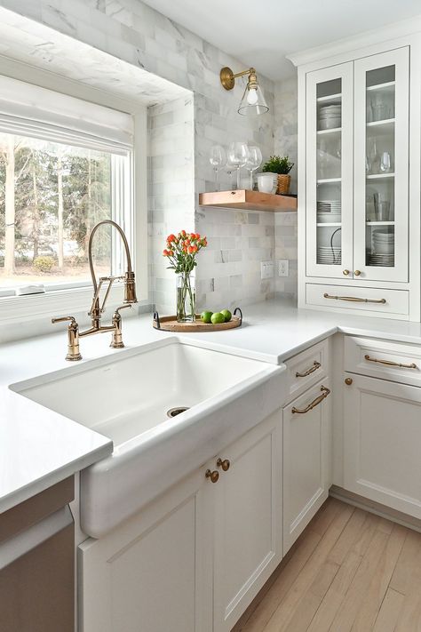 A larger window brings in more light and connects the space to their lush garden. The client chose a traditional farmhouse sink and polished gold Brizo faucet, which also matches the pot filler faucet. Farmhouse Sink Gold Faucet, Sink Window Kitchen, Gold Kitchen Sink Ideas, Farmhouse Sink With Gold Faucet, Farmhouse Pot Filler, Brizo Faucet, Kitchen Sink Backsplash, Gold Pot Filler, Gold Sink Kitchen