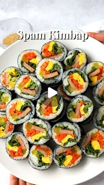 Christie Lai on Instagram: "Spam Kimbap 📝 Recipe link in profile or visit www.christieathome.com & search for recipe  Delicious Korean style sushi rolls filled with warm rice, spam, lettuce, pickled radish, egg and carrots. It looks like sushi but it’s not. Kimbap is a Korean dish made with mostly cooked ingredients. The roll is then brushed with sesame oil and garnished with sesame seeds, unlike sushi. Equally as delicious and a favorite in this household.   #recipe #recipeoftheday #recipes #recipeshare #easyrecipes #newrecipe #asianeats #asiancooking #asianfoodlover #asianfoodie #asianfoodporn #asianfood #Asianfoods #asianrecipes #asiancuisine #asiancooking #asianfoodrecipes #koreancooking #koreanfoods #koreanfood #koreanfoodporn #koreancuisine #koreanrecipe #koreanfoodie #kfood #kimbap Spam Kimbap, Kimbap Recipe, Pickled Radish, Pickled Radishes, Korean Cooking, K Food, How To Make Sushi, Korean Dishes, Asian Cooking