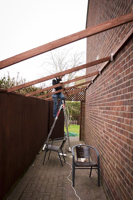 Side passage support beams going on | My husband attaching s… | Flickr Outside Storage Shed, Side Yard Landscaping, Side Yards, Support Beams, Carport Designs, House Extension Design, Backyard Sheds, House Siding, Lego Worlds