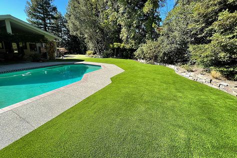 Why Artificial Turf Around the Pool Is Better than Real Grass Fake Turf Around Pool, Pool Artificial Turf, Artificial Turf Around Pool Swimming, Artificial Grass Backyard Pool, Turf Grass Around Pool, Turf Pool Area, Concrete And Turf Pool Deck, Astroturf Around Pool, Pool With Grass Around It