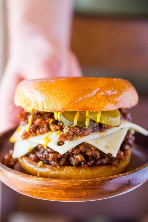 Cuban Sloppy Joes with seasoned ground pork with citrus flavors topped with Swiss cheese pickles and mustard is a Cuban take of the favorite sloppy joes! | #sloppyjoes #sloppyjoe #pork #groundpork #swisscheese #cuban #dinnerthendessert #dinner #dinnerrecipes Sloppy Joes Dinner, Cheese Pickles, Cuban Pork, Dinner Then Dessert, Ground Pork Recipes, Sloppy Joes Recipe, Sloppy Joe, Cuban Recipes, Burgers Sandwiches