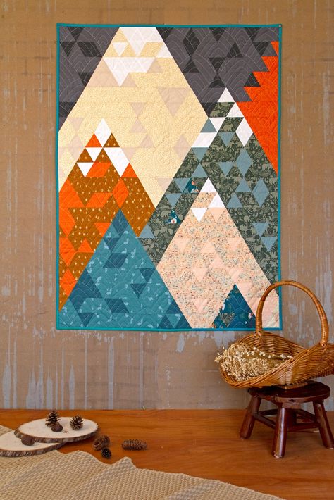 Experience the beauty of the great outdoors from the comfort of your home with our stunning Free Quilt Pattern 'Mountains'. Featuring the rich, colorful, and whimsical prints from Timberline by Jessica Swift, this quilt is sure to be a showstopper in any space. Download the pattern and immerse yourself in the enchanting world of Timberline. Happy Quilting! 🧵 Mountains Quilt, Mountain Quilt Pattern, Woodland Baby Quilt, Fox Quilt, Tree Quilt Pattern, Mountain Quilts, Diy Fabric Crafts, Quilt Fabric Collections, Landscape Quilts