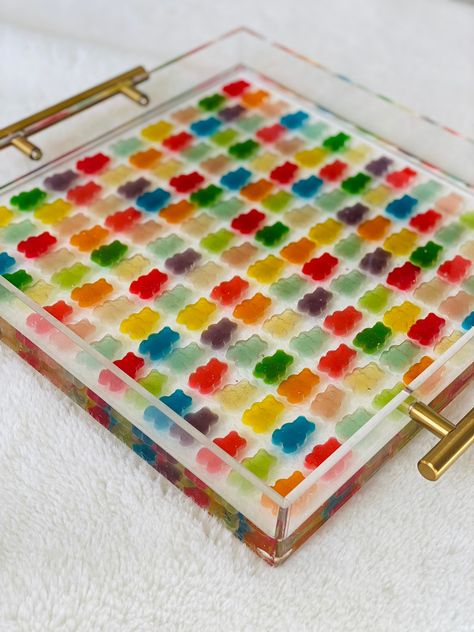 "Bring a pop of color and sweetness to your home with a unique and handcrafted acrylic tray. Filled with a delicious assortment of vibrant gummy bears, this tray is the perfect addition to any room. Each tray is made to order and I will use a variety of random colored gummy bears. No two trays are the same. You can choose either the 12\" x 12\" tray or the smaller 10\" x 10\" tray. It will be sealed with epoxy resin and a touch of glitter for a glossy finish. Treat yourself or gift it to a loved Diy Resin Table, Candy Tray, Gummy Bear Candy, Epoxy Table Top, Tray Coffee Table, Epoxy Resin Diy, Flower Resin Jewelry, Diy Resin Projects, Coffee Table Tray