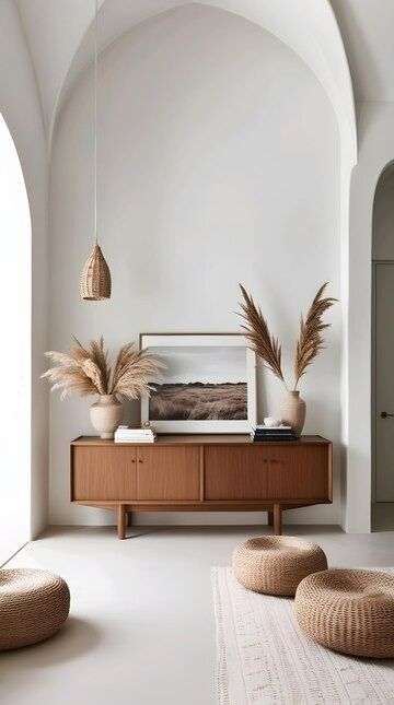 A table with two planters on it and a picture on the wall | Premium AI-generated image Grass Interior, Mediterranean Style Interior, Woven Pendant Light, Arched Doorways, Picture On The Wall, Dried Pampas, A Stack Of Books, Elegant Wall Art, Wooden Sideboard