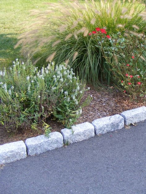 Standard granite cobblestones used as driveway edging. Granite cobblestones are an ideal paving material for driveways because of their long-lasting quality and textured finish, which provides traction on steep surfaces. Fence Border Landscaping, Border Landscaping, Driveway Edging, Fence Border, Edging Stones, Cobblestone Driveway, Stone Edging, Privacy Landscaping, Driveway Landscaping