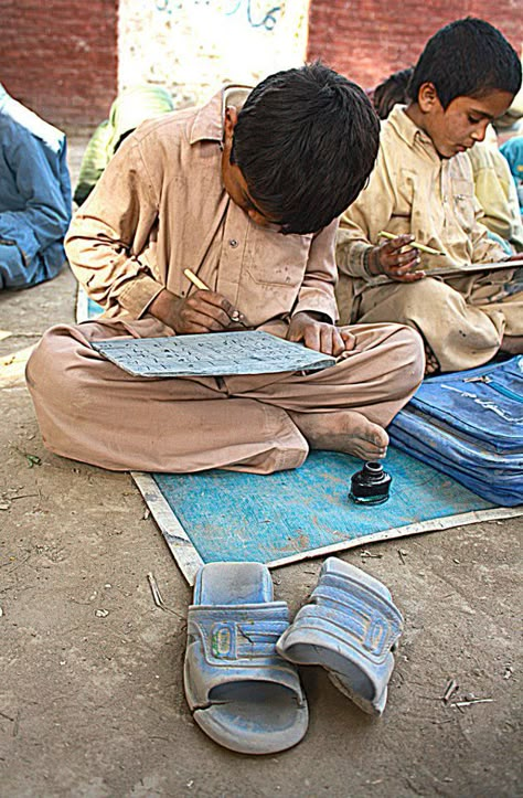 Student of a village elementary school practices writing on his note-book folded like a ‘takhti’, Lode A Dio, Pakistani Art, Pakistani Culture, Schools Around The World, Diy Fashion Scarf, Education In India, Two Sons, Village Photography, Islamic Republic