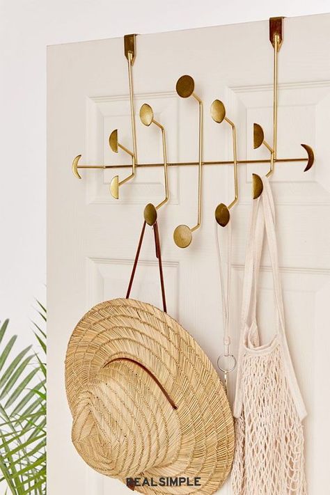 8 Genius Over-the-Door Organizers, All Under $50 | Truth: back-of-door organizers aren't exactly known for looking cute. That is, until this golden moon phase multi-hook rack was created. Slip it over the top of your closet door to hold sun hats, beach bags, and scarves. #declutter #organizationtips #realsimple #storageideas #storagetips Over The Door Organizer, Over The Door Hooks, Door Organizer, Tiny Space, Dorm Room Essentials, Door Hooks, Inviting Home, Boho Chic Furniture, Floral Tapestry