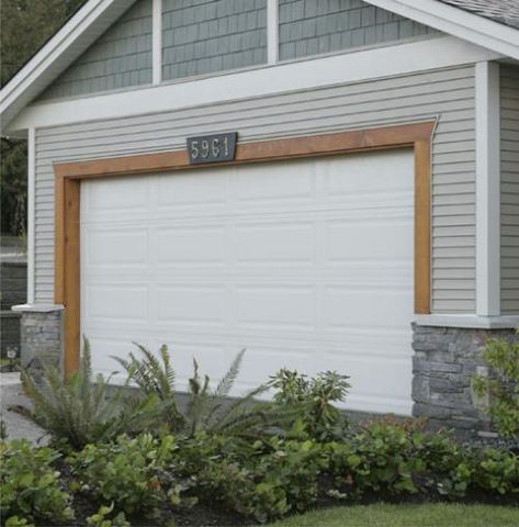 stain wood trim around garage door Wood Trim Around Garage Door, Wood Trim Garage Door, Wood On Garage Door, Cedar Accent Above Garage Door, Trim Around Garage Doors, Garage Trim Ideas Exterior, Cedar Door Trim, Cedar Garage Door Farmhouse, Wood Accent Above Garage Door