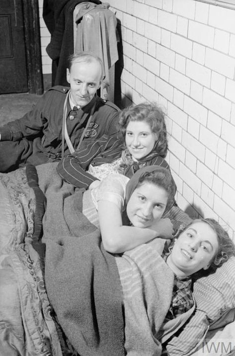 An Air Raid Precautions (ARP) warden, wearing Pattern No.41 overalls, sits with three young women in a public shelter in the Islington area, London, during the Second World War. 1940s Britain, Ww1 Tunnellers, Women In Wartime, 1940s Army Woman, Ww1 Hospital, Airborne Army, Operation Market Garden, Air Raid Shelter, British Home