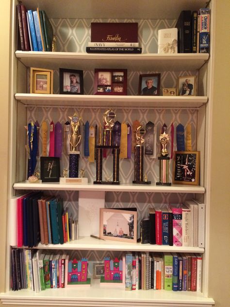 Bookshelf organization, dance trophy display, ribbon display using tension rod Trophy Cabinet Ideas, Dance Trophy Display Ideas, Trophy And Medal Display Ideas, Trophy Shelf Ideas, Bookshelf Organization Ideas, Medal Display Ideas, Award Shelves, Trophy Display Shelves, Dance Trophy