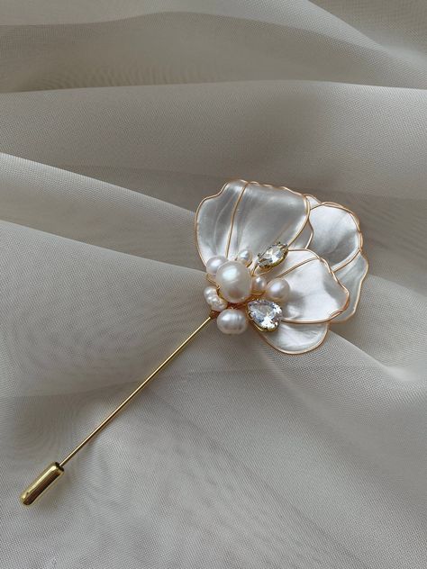 "Delicate petals with pearl shimmer and natural freshwater pearl are interviwed into gorgeus Floral brooch. It`s will be Magnificent accessory for your sweater/jacket/dress or coat! Flower brooch whole handcrafted with a special Japaneese polymer resin, every detail is handmade with meticulous atteention to every element! * Made of Gold plated wire and pin, UV resin, freshwater pearls and cubic zircons; * Total length around 4 in, flower~1.77in, pin thickness~0,027in; * Color: gold, ivory; * If Flower Brooch Handmade, Brooch Handmade, Floral Brooch, Handcrafted Accessories, Classy Jewelry, Handmade Beaded Jewelry, Gold Brooches, Flower Accessories, Pearl Brooch