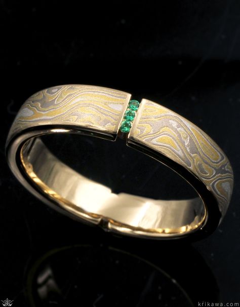 Vertical Floating Diamond Mokume Wedding Band customized here in Summer Mokume Gane, 14k yellow gold and green emeralds! Suspended between two opposite channels are three small diamonds that appear to float within the negative space. The straight band is inlaid with your favorite mokume gane flavor. Men’s Wedding Band With Emerald, Unique Male Wedding Rings, Unusual Wedding Rings Men, Unique Men’s Rings, Men’s Diamond Ring, Men’s Engagement Ring, Mens Wedding Bands With Diamonds, Masculine Engagement Rings, Green Wedding Band