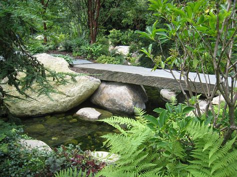 bridge Walkout Patio, Plank Bridge, Water Feature Garden, Cascade Garden, Garden Bridge Design, Riverside Landscape, Backyard Bridges, Garden River, Garden Pavers