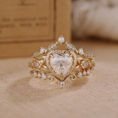 ✦ABOUT THIS ITEM ✦INFORMATION ● Engagement Ring: --main stone: Moissanite --stone size & shape: 6mm & Heart cut --side stones: Moissanite --side stone weight: approximately 0.22ct ● Wedding Band 1 (bottom): --stone: Moissanite --stone weight: 0.16ct --shape: round --band width & thickness: 1.3mm & 1.2mm ● Wedding Band 2 (top): --stone: Moissanite & Pearl --stone weight: 0.17ct --shape: round --band width & thickness: 1.3mm & 1.2mm ✦SERVICES: --Custom orders --Rush order & overnight shipping --Pa Wedding Rings Heart Shaped, Non Traditional Wedding Rings Engagement, Fairy Wedding Rings, Nora Sermez, Engagement Rings With Wedding Bands, Engagement Ring Aesthetic, Color Engagement Rings, Gold Wedding Rings For Women, Anniversary Gifts For Girlfriend