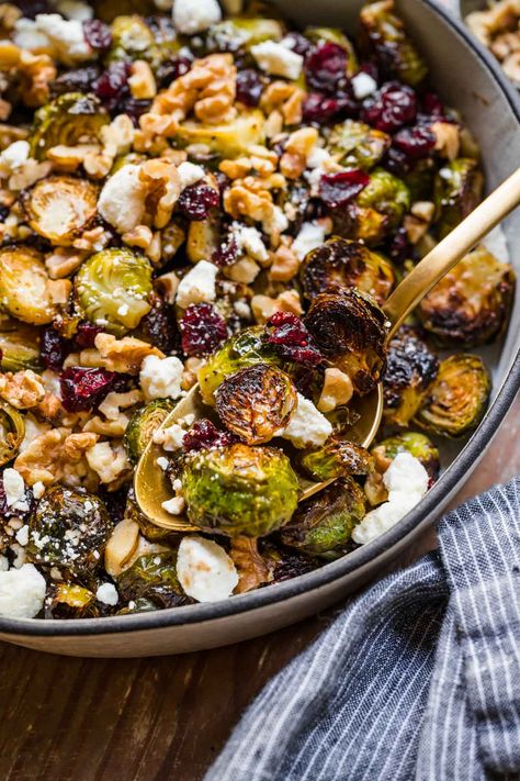 Cranberry Goat Cheese Brussels Sprouts in a serving bowl with spoon Brussel Sprout Goat Cheese Recipes, Brussel Sprout Recipes With Feta Cheese, Roasted Brussel Sprouts Goat Cheese, Brussel Sprouts Goat Cheese, Brussel Sprouts Feta Cranberry, Goat Cheese Brussel Sprouts, Roasted Brussel Sprouts With Goat Cheese And Pomegranate, Cranberry Goat Cheese, Goat Cheese Recipes