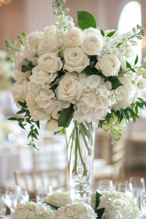 Floral centerpieces are a timeless choice, offering endless ways to add personality to your wedding. See more ideas here. White Flower Wedding Centerpieces, Wedding Centre Piece Ideas, White Centerpiece Wedding, Elegant Wedding Centerpieces, Contemporary Wedding Decor, Woodland Wedding Centerpieces, Minimalist Centerpiece, Rose Wedding Theme, White Wedding Centerpieces