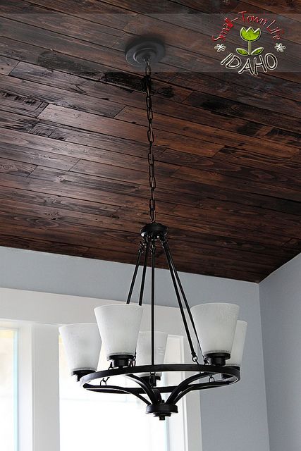 Our Small-Town Idaho Life: HOUSE UPDATE {stone, lighting, wood floors} Wood Ceiling Bedroom, Wood Basement, Ceiling Planks, Basement Ceiling Ideas, Pallet Ceiling, Plank Ceiling, Basement Ceiling, Bedroom Light Fixtures, Into The Wood