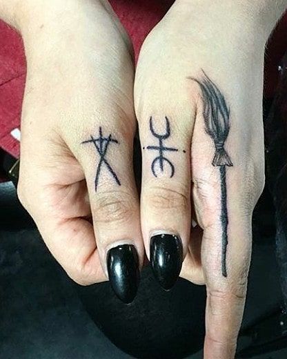 In a society captivated by grandiose ink masterpieces, small hand tattoos serve as a subtle yet impactful way to express your individuality. Oh yes, the days when hand tattoos were reserved for elements of questionable occupations only are far and gone, and we cannot be happier about it Occult Finger Tattoo, Finger Tattoo Witch, Tiny Witch Tattoo Finger, Broom Finger Tattoo, Finger Tattoos Spooky, Alternative Finger Tattoos, Cute Thumb Tattoos, Horror Finger Tattoos, Blair Witch Project Tattoo