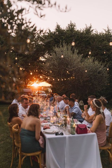 Wedding guests sit outdoors for al fresco dining with stunning sunset Dinner Al Fresco, Pastel Wedding Theme, Croatia Wedding, Dinner Party Wedding, Destination Wedding Favors, Destination Wedding Welcome Bag, Art Nouveau Weddings, Stunning Sunset, Pastel Theme