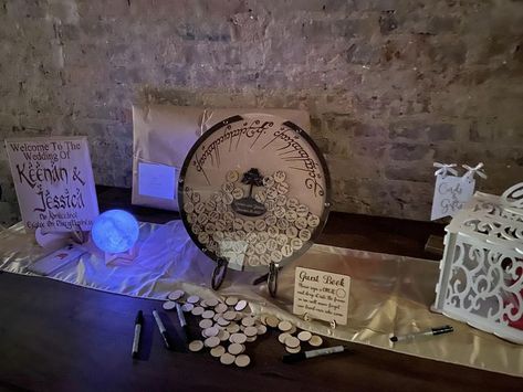 Lord of the rings welcome table with guest book wall decoration from etsy Middle Earth Wedding, Lord Of The Rings Wedding, Wedding Welcome Table, Lotr Wedding, Geek Wedding, Welcome Table, Book Wall, Halloween Wedding, Rings Wedding