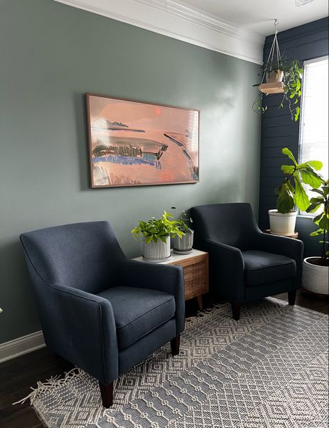 Loving these navy chairs, green walls, and of course the frame TV in our living room! Follow my shop @CharlestonCrafted on the @shop.LTK app to shop this post and get my exclusive app-only content! #liketkit #LTKFind #LTKfamily #LTKhome @shop.ltk Dark Blue And Sage Green Living Room, Green Tv Room Ideas, Green Wall Blue Sofa, Navy Couch Green Walls, Blue Green Cream Living Room, Navy Green Living Room, Sage Green And Navy Living Room, Green Navy Living Room, Blue And Sage Green Living Room