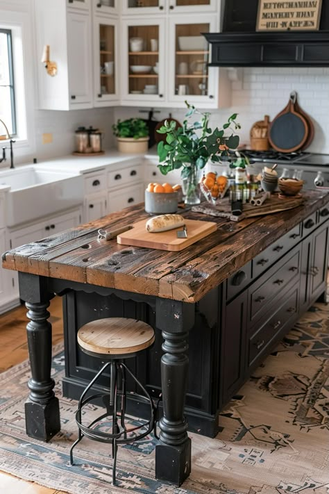 Modern rustic kitchen with a farmhouse kitchen island table made of reclaimed wood, accented by white cabinets and a decorative rug underneath. Antique Island In Kitchen, Kitchen Island Desk Ideas, Antique Furniture Kitchen Island, Harvest Table Island, Island Kitchen Ideas Farmhouse, Kitchen Table As An Island, Kitchen Islands As Dining Tables, Drapers Table Kitchen Island, Antique Island Kitchen