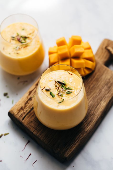 Creamy three ingredient Indian Mango Lassi recipe - this thick and chilled drink is made with yogurt, mangoes and milk and is full of probiotics and super healthy. Use fresh mangoes or frozen mango puree - either way you’ll love it!  #lassi #curd #yogurt #authentic #smoothie #milkshake Mango Lassi Recipe, Peach Mango Smoothie, Mango Lassi Recipes, Lassi Recipe, Healthy Summer Drinks, Indian Mango, Lassi Recipes, Mango Drinks, Banana Splits