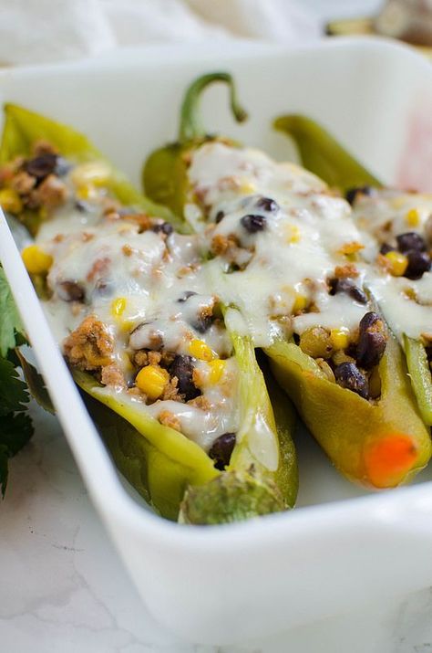 Stuffed Hatch Peppers - delicious spicy hatch chiles stuffed with ground turkey, black beans, corn, salsa, and topped with monterey jack cheese. Easy and healthy dinner!