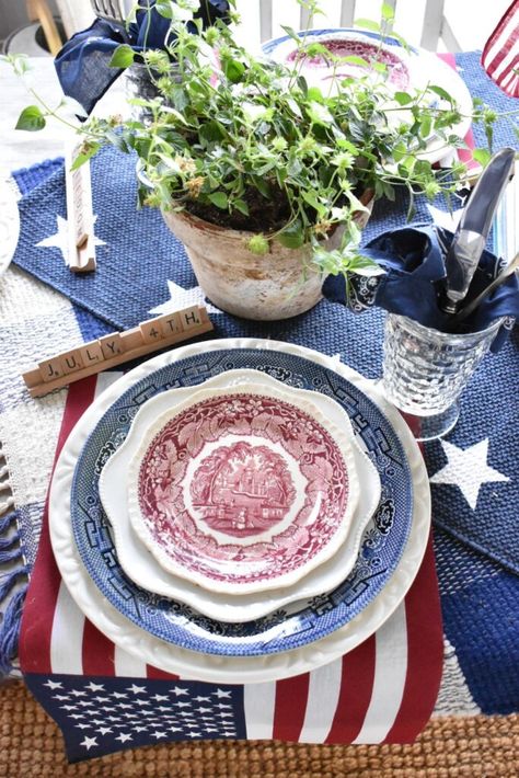 This red, white and blue tablescape is perfect for a Memorial Day, July 4th or Labor Day party. Layered blue transferware, red transferware and basic white plates were perfect for this patriotic themed table. I love how the flag "placemats" turned out and the thrifted layered rugs I used for table runners. And a vase filled with baseballs definitely screams SUMMER. This tablescape is perfect for a Memorial Day, July 4th or Labor Day party. American Flag Dessert, White And Blue Tablescape, Flag Desserts, Blue Tablescape, July 4th Holiday, Blue Centerpieces, Transferware Plate, Small Flags, Berry Baskets