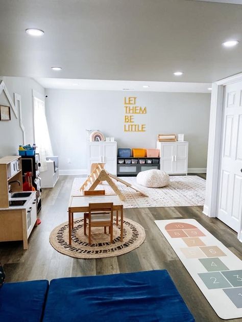 Playroom With Wood Floors, Playroom In Main Living Area, Montessori Office Decor, Tv Room For Kids Playrooms, Long Playroom Ideas, Montessori Basement Playroom, Playroom For One Year Old, Small Daycare Layout, Rectangle Playroom Layout