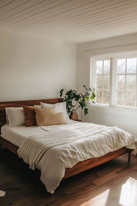 Create a peaceful minimalist bedroom by embracing clean lines, neutral colors, and smart storage solutions. Opt for simple furniture with hidden storage to keep the space clutter-free. Add warmth with natural wood tones and soft textiles for a calming atmosphere. 🛏🌿 Primary Bedroom Minimalist, Small Calm Bedroom, Minimal Natural Bedroom, Simple Neutral Bedroom Decor, Clean Bedroom Inspiration, Bedroom White And Wood, Airy Bedroom Aesthetic, Minimalist Master Bedrooms Decor, Simple Clean Bedroom