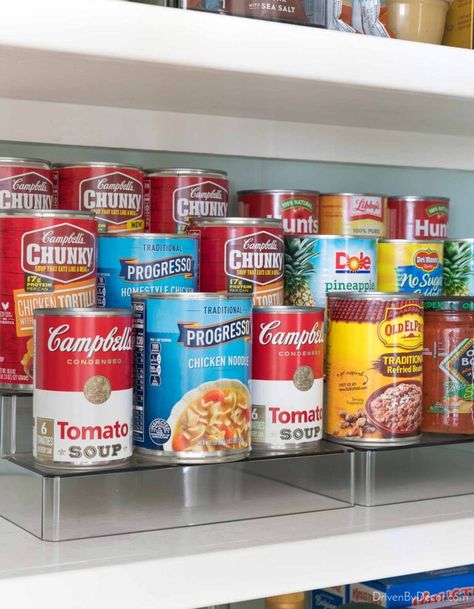 Organized kitchen cabinet with tiered organizer for cans Tiered Organizer, Cabinet Organization Ideas, Pantry Interior, Revolving Spice Rack, Free Pantry, Kitchen Cooktop, Cabinet Storage Solutions, Kitchen Cabinet Organization Ideas, Canned Food Storage