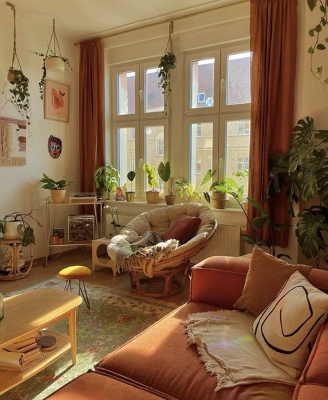 Cottagecore Apartment Decor Cozy, Modern Boho Chic Living Room Retro, Green And Orange Boho Living Room, Modern Earthy Apartment, Earthy Retro Living Room, Plant Filled Studio Apartment, Cute Apartment Aesthetic Living Room, Papasan Chair Living Room Ideas, Vintage London Apartment