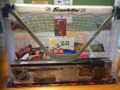 Candy basket for a hockey tournament. Hockey Tournament Raffle Basket, Hockey Basket Raffle Ideas, Hockey Raffle Basket, Hockey Gift Basket Ideas, Hockey Raffle Basket Ideas, Hockey Gift Basket, Hockey Tournament Ideas, Hockey Basket, Hockey Manager