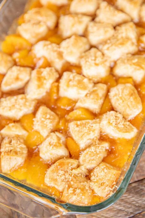 Peach Cobbler Bubble Up - a fun twist to peach cobbler! Only 5 ingredients and ready in about 30 minutes. Refrigerated biscuits, peach pie filling, canned peach slices, cinnamon, and brown sugar. We like to serve this slightly warm with a big scoop of vanilla ice cream! SO good!! #cobbler #peach #biscuits #potluck #dessert Peach Biscuit Cobbler, Bubble Up Dessert Recipes, Peach Cobbler Using Canned Biscuits, Peach Cobbler With Canned Biscuits, Biscuit Bubble Up Recipes, Peach Cobbler Biscuits, Peach Pie Filling Canned, Peach Cobbler With Biscuits, Biscuit Cobbler