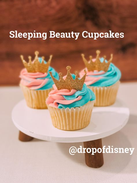 Celebrate World Princess Week with these Sleeping Beauty Cupcakes! These vanilla cupcakes are topped with a swirl of pink and blue frosting and a golden crown! #disney #cupcakes #sleepingbeauty Pink Princess Cupcakes, Pink And Blue Swirl Cupcakes, Sleeping Beauty Cupcakes, Aurora Cupcakes, Princess Snacks, Sleeping Beauty Birthday, Sleeping Beauty Birthday Party, Beauty Party Ideas, Sleeping Beauty Cake