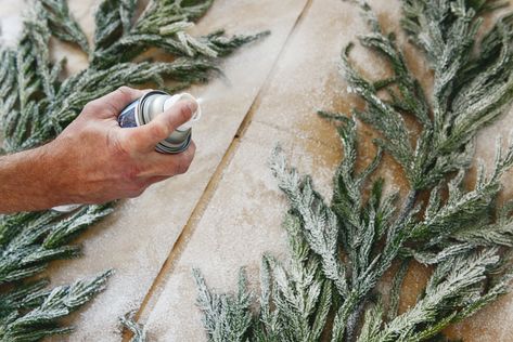 Detail shot of spraying Sno Blast on two strands of faux garland | Which flocking spray is best? | How to flock your own holiday garland, tree and decor, via Yellow Brick Home Flocking Garland Diy, How To Flock Garland, Pine Garland Christmas, Faux Garland, Flocked Garland, Christmas Candles Diy, Yellow Brick Home, Holiday Garland, Ceiling Texture