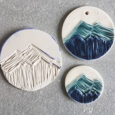 Heather Kegel on Instagram: “So here's the result from a few posts back. 🌲 I have been wanting to make mountain ornaments and magnets for some time, but was not ready…” Clay Mountains Diy, Mountain Polymer Clay, Ceramic Magnets Ideas, Mountain Ceramics, Mountain Ornaments, Pottery Magnets, Clay Mountain, Mountain Sculpture, Ceramic Mountain