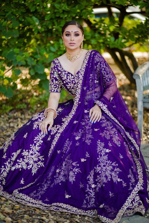 Pansy - Purple Dupion silk Lehenga Choli with Zari & Jerkin handwork Let your soul blossom as vibrant as the orchids this season in this angelic purple ethnic wear set, made just for you! Sweetheart neck blouse with sequins with jerkin Exquisite sweetheart neckline Flattering princess cut fitting Sophisticated mid-length sleeves Opulent floral sequins handwork Gold Jerkin & Zari work adds class Gored silk skirt lehenga w/ Zari & Jerkin embroidery Flared Gored patterned skirt lengha Dupion silk f Purple Ethnic Wear, Purple Wedding Lehenga, Diwali Pics, Sweetheart Neck Blouse, Indo Western Lehenga, Skirt Lehenga, Western Lehenga, Sequin Lehenga, Purple Lehenga