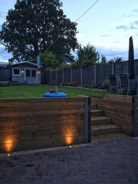 Finished retaining sleeper wall, steps, block paving driveway and exterior LED garden lighting Lights In Sleepers Garden, Mid Century Modern Retaining Wall, Driveway Retaining Wall, Sleeper Steps, Retaining Wall Patio, Sleeper Wall, Sleeper Retaining Wall, Paving Driveway, Sleepers In Garden