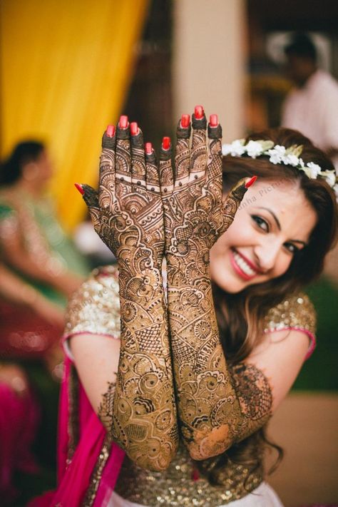 Photo of Bride showing off traditional bridal mehendi Mehendi Photography Bridal, Mehendi Photoshoot, Bridal Mehendi Designs Wedding, Mehendi Photography, शादी की तस्वीरें, Indian Bride Poses, Indian Bride Photography Poses, Indian Wedding Poses, Bride Photos Poses