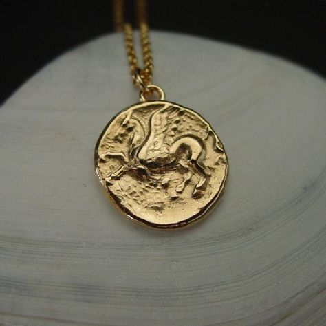 Small Percy Jackson necklace handmade from a Pegasus coin from ancient Greece.Pegasus the winged divine stallion is usually depicted as pure white in color. He was sired by Poseidon, in his role as horse-god, and foaled by the Gorgon Medusa.Greco-Roman poets write about his ascent to heaven after his birth and his obeisance to Zeus, king of the gods, who instructed him to bring lightning and thunder from Olympus.Popular character in games such as Dungeons and Dragons and Magic The Gathering.• Th Percy Jackson Jewelry, Percy Jackson Necklace, Lightning And Thunder, Gorgon Medusa, Ancient Roman Coins, Ancient Greek Coin, Greco Roman, Lion Pendant, Greek Coins